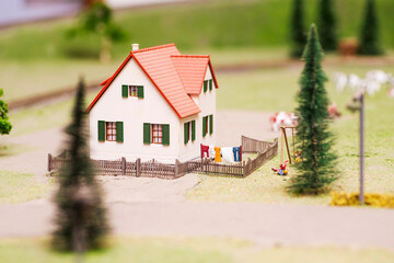 Miniature toy farm house. Rural landscape. Landscape with a house