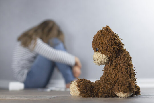 Psychological health concept. Teddy bear and teenage girl in the background is out of focus. Psychological assistance for children and adolescents, suicides and teenage depression.
