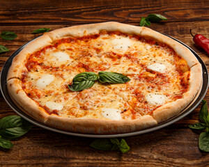 Pizza margarita with spices and basil on wooden background