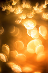 Yellow christmas light blurred and bokeh. Background concept. Vertical frame. Amazing holiday golden color texture.