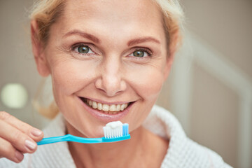 Portrait of middle aged caucasian woman with toothbrush