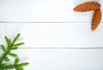 Christmas decoration green fir branches and Bumps on white wooden board