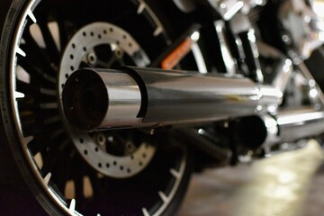 Big black exhaust pipes of a motorbike view from rear