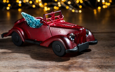 toy red car with a tree on a blurred background with bokeh