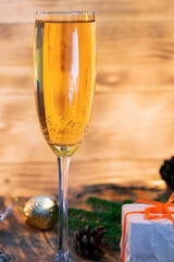A glass of champagne.Bubbly. A goblet of Sparkling wine. A wineglass of Fizz. Christmas background. A candle champagne.