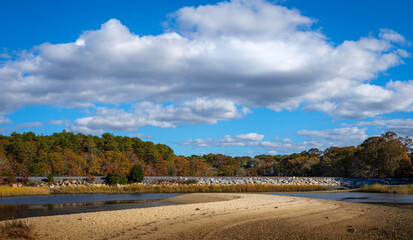 Dramatic cloudscape over the swirling sandbar in the marsh at low tide on Cape Cod