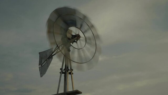 Low angle, spinning windmill in Utah