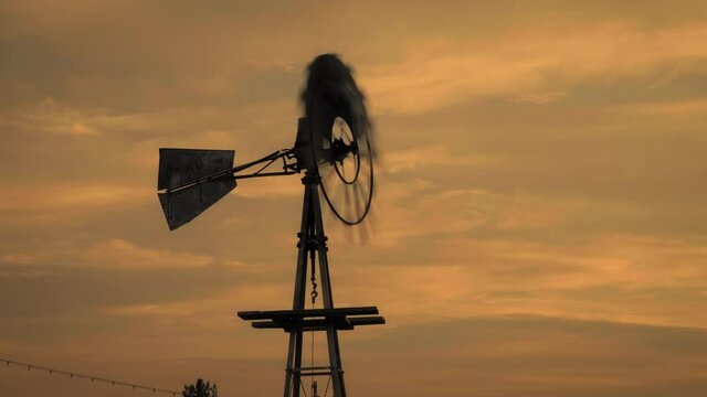 Utah windmill during colorful sunset, low angle