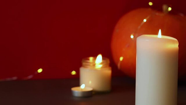 lighted candles with pumpking on table. Halloween atmosphere, decoration