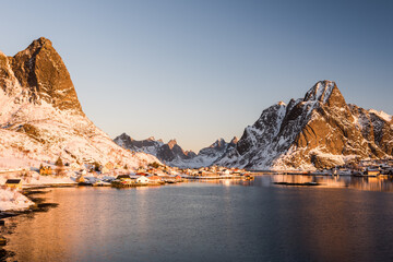 The small fishing village Reine on the Lofoten islands in Norway in winter with steep snowcapped...