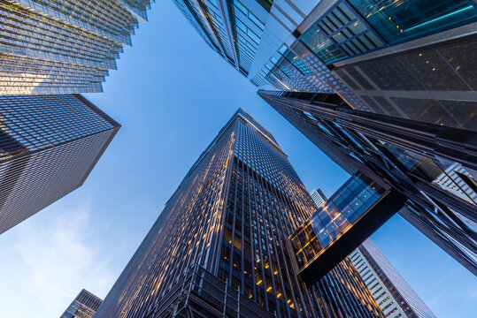 Office buildings stretch up to the blue sky in the financial district in downtown Toronto Canada.