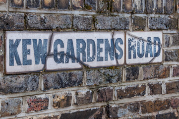 Fototapeta premium Kew Gardens Road sign on a brick wall.