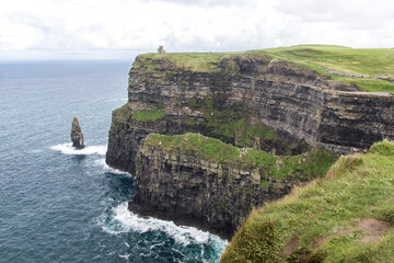 CLIFFS OF MOHER, COUNTY CLARE, IRELAND - SEPTEMBER 13, 2018: Famous Irish landscape on a windy,...