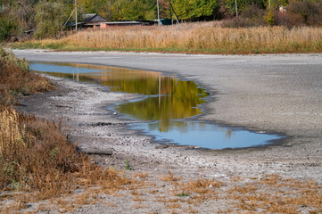 Photo of dried river in autumn and sky reflection in it