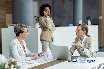 Female entrepreneurs talking while having business meeting in the office.