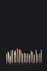 Burning candles on a black background