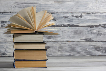 Open book, hardback books on wooden table. Back to school. Copy space