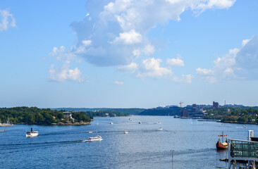 Fototapeta na wymiar Many boats and yachts sailing at Sea Gulf in downtown area of Stockholm In summer sunny day. Sweden