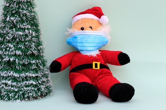 Santa Claus With Face Mask And Christmas Tree