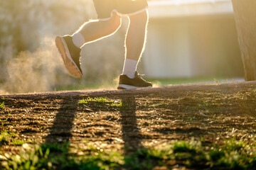 man runner up dust while running, blurred backlight motion practicing sport fitness and healthy lifestyle concept