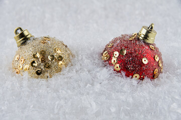 Red and Gold Christmas baubles on snow