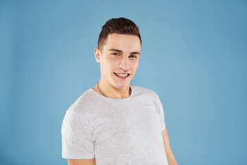 Emotional man in white t-shirt cropped view on blue background lifestyle