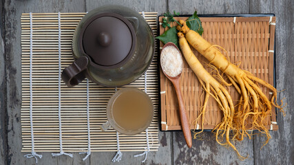 Fresh Ginseng root with a cup of hot tea ,The concept of healthy drink