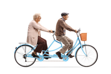 Elderly man and woman riding a blue tandem bicycle