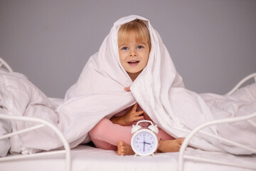 Cute baby girl in bed before bed