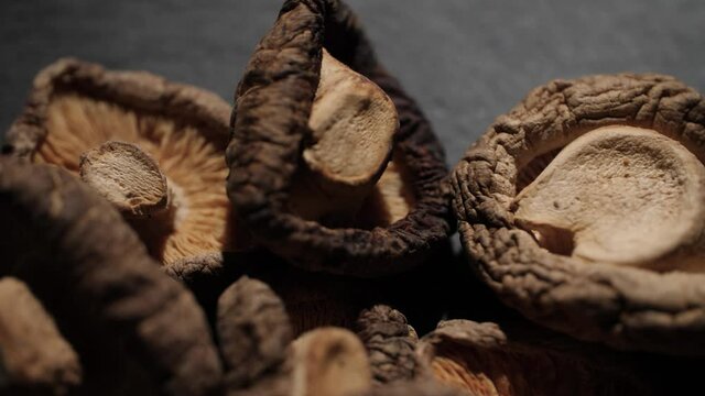 4K Close up of Shiitake mushrooms often used in Japanese and Chinese cooking. Rotating macro shot of the dried mushrooms that shows the beautiful and delicate texture of the Asian ingredient.