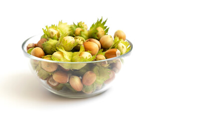 Hazelnuts in a plate on a white background. Fresh ripe nuts. Copy space.