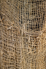 weave of thick and rough frayed ropes - texture of an old rustic and damaged net