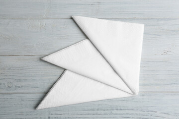 Clean napkins on white wooden table, flat lay