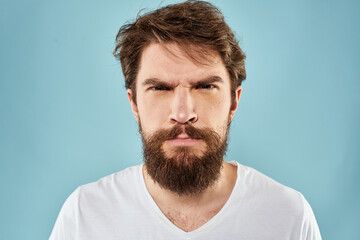 Obraz premium Bearded man emotions facial expression gestures hands close-up blue background