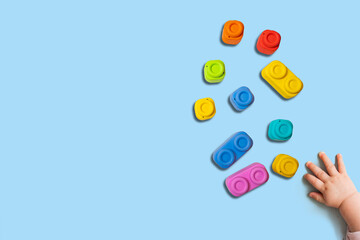 Baby playing with colorful blocks, intelligence concept. top view, copy space