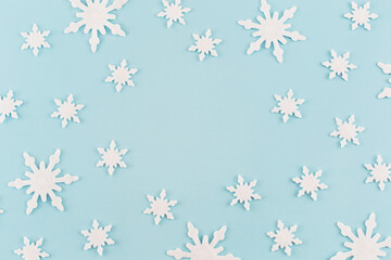 Christmas composition. Snowflakes on blue background. Christmas, winter, new year concept. Minimal style. Flat lay, top view, copy space.
