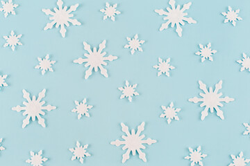 Christmas composition. Pattern made of snowflakes on blue background. Christmas, winter, new year concept. Minimal style. Flat lay, top view.