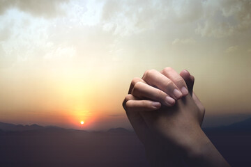 Human hands raised while praying to god