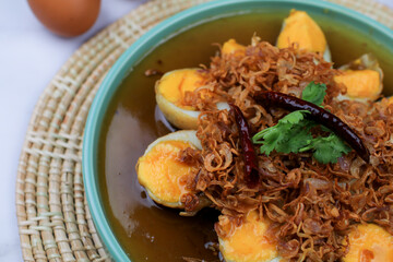 Fried egg with tamarind sauce or Sweet and Sour Eggs topped with fried onions and dried chilies. Thai food / Select focus