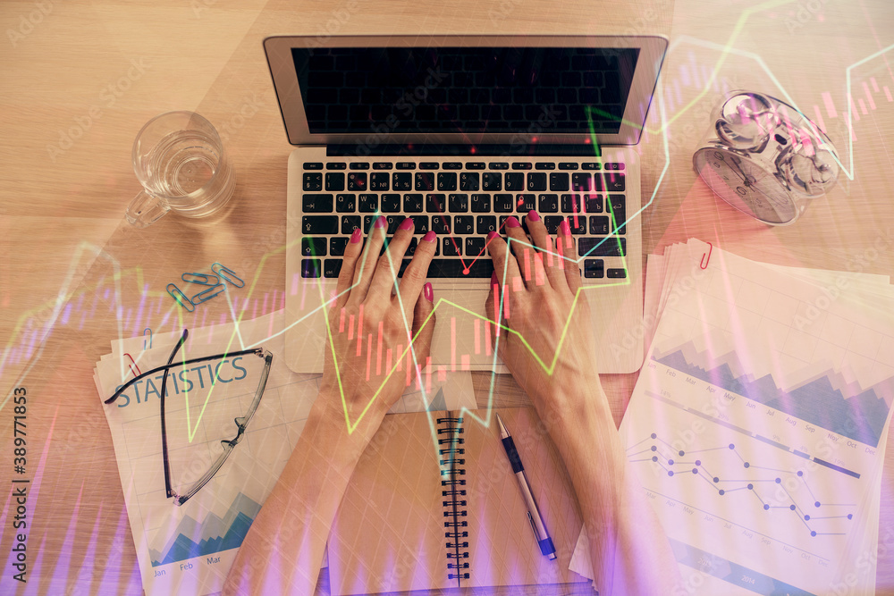 Poster double exposure of woman hands working on computer and forex graph hologram drawing. top view. finan