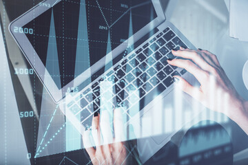 Double exposure of woman hands working on computer and forex chart hologram drawing. Top View. Financial analysis concept.