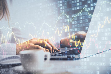 Double exposure of woman hands working on computer and forex graph hologram drawing. Financial...