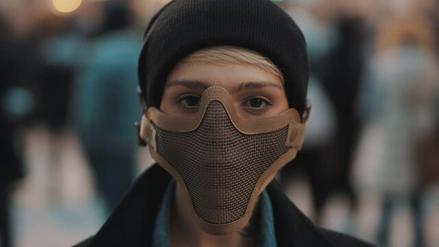 Portrait of young woman with face mask in the crowd. High quality 4k footage