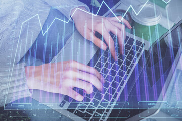 Double exposure of woman hands typing on computer and forex chart hologram drawing. Stock market invest concept.