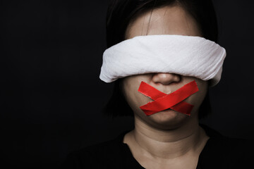 Slave Asian woman blindfold wrapping mouth with red adhesive tape, tied with chains and closed her...
