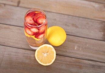 Fresh lemon and a cup of lemon strawberry tea