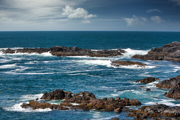 Waves are raging against the rocky cliffs of Tofino, Vancouver Island, Bc. Canada