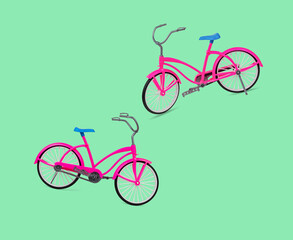 Two pink bicycles on a green background.