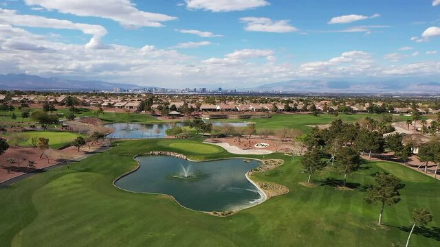 HD drone footage of residential neighborhood with golf course in Henderson, Nevada, no people, clouds, green grass