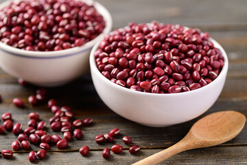 Azuki beans or red mung beans in a bowl and spoon on wooden table